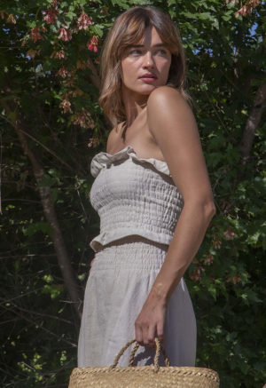 Front/side view of straight size model wearing Oatmeal Linen Ruched Swing Skirt.