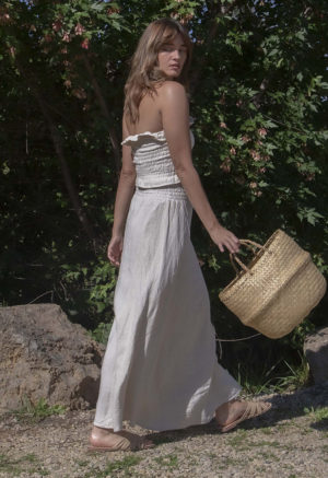 Side/back view of straight size model wearing Oatmeal Linen Ruched Swing Skirt.
