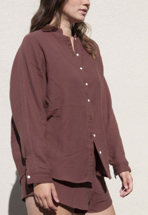 Front/side view of straight size model wearing Raisin Gauze Long Sleeve Dolman Button-Up Top.
