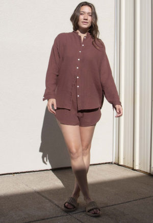 Front view of straight size model wearing Raisin Gauze Long Sleeve Dolman Button-Up Top.