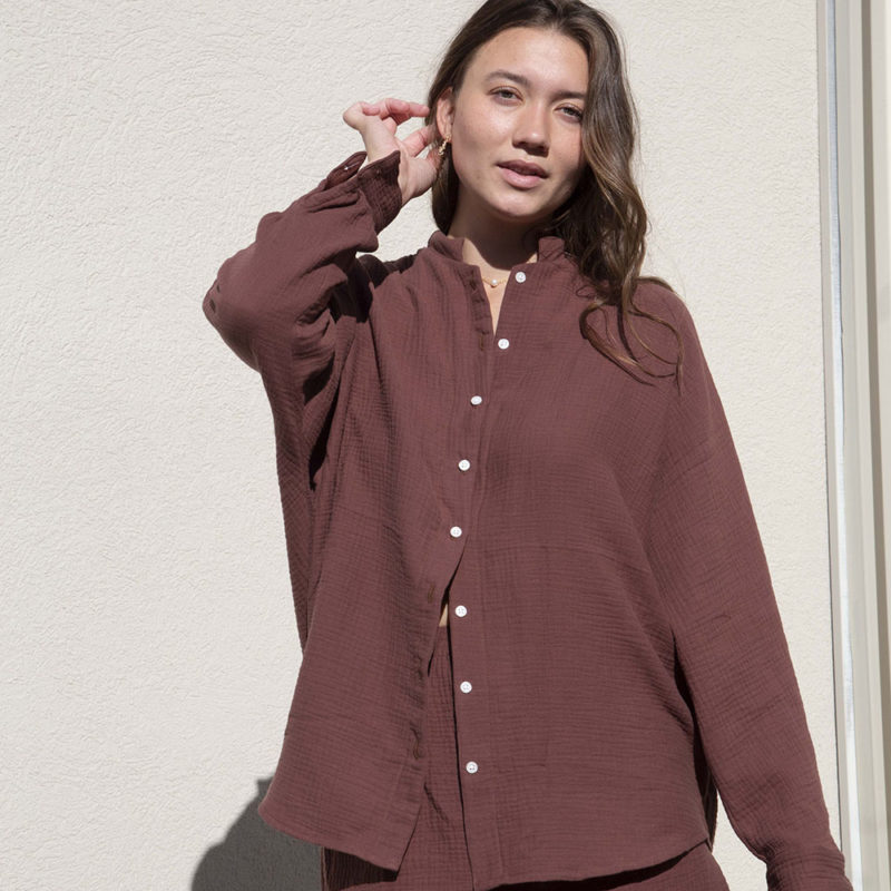 Front view of straight size model wearing Raisin Gauze Long Sleeve Dolman Button-Up Top.