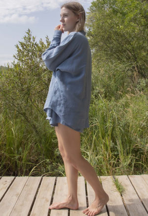 Side view of straight size model wearing Denim Linen Long Sleeve Dolman Button-Up Top.