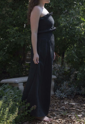 Side view of straight size model wearing Black Linen Ruched Swing Skirt.