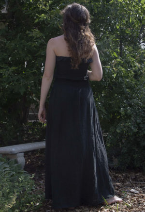 Back view of straight size model wearing Black Linen Ruched Swing Skirt.