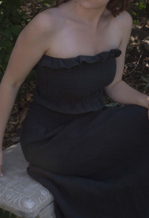 Front/side view of straight size model wearing Black Linen Ruched Swing Skirt.