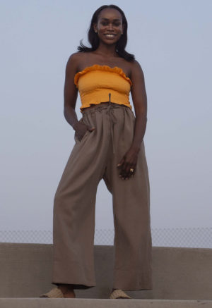 Front view of straight size model wearing Gold Ruffle Tube Top.