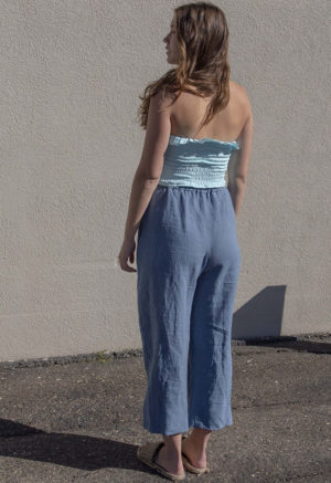 Back view of straight size model wearing Capri Blue Ruffle Tube Top.