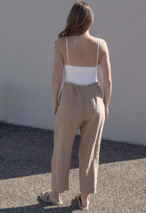 Back view of straight size model wearing Ivory Rib Straightaway Bodysuit.