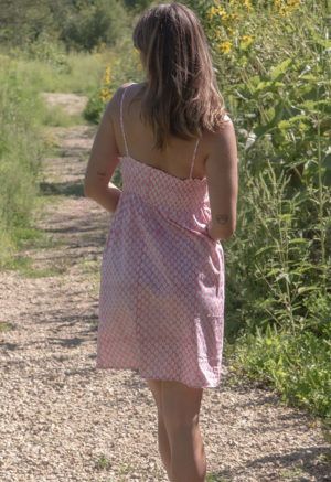 Back view of straight size model wearing Pink & White Leaves Straightaway Knee Length Slip Dress.
