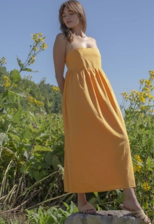 Front/side view of straight size model wearing Gold Straightaway Midi Dress.