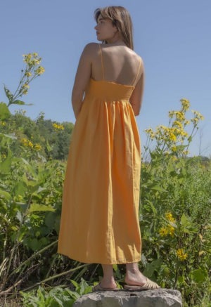 Back view of straight size model wearing Gold Straightaway Midi Dress.