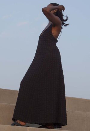 Side view of straight size model wearing Black Check V-Neck Maxi Slip Dress.