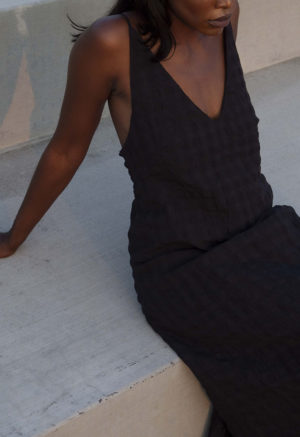 Front/side view of straight size model wearing Black Check V-Neck Maxi Slip Dress.