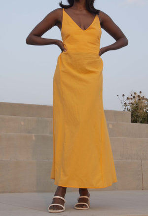 Front view of straight size model wearing Gold V-Neck Maxi Slip Dress.