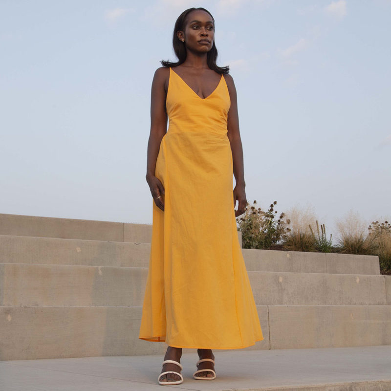 Front view of straight size model wearing Gold V-Neck Maxi Slip Dress.