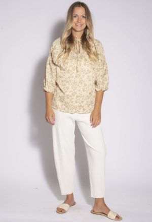 Front view of straight size model wearing Almond Floral Tie Neck Gathered Sleeve Top.