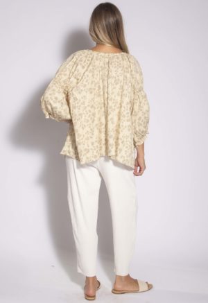 Back view of straight size model wearing Almond Floral Tie Neck Gathered Sleeve Top.