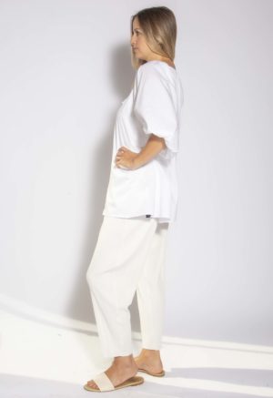 Side view of straight size model wearing White Drawstring Neck Peasant Blouse.