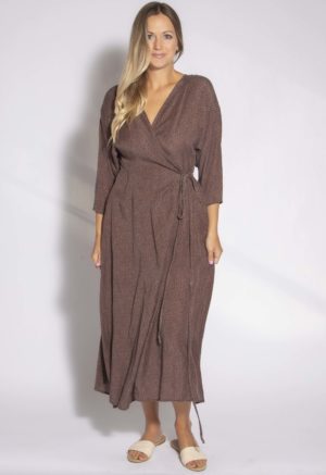 Front view of straight size model wearing Brown with Black Spots Wrap Dress.