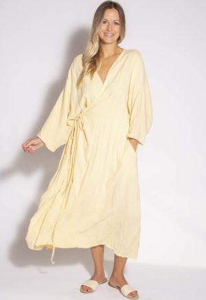 Front view of straight size model wearing Italian Straw Long-Sleeve Wrap Dress.
