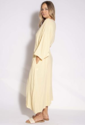 Side view of straight size model wearing Italian Straw Long-Sleeve Wrap Dress.