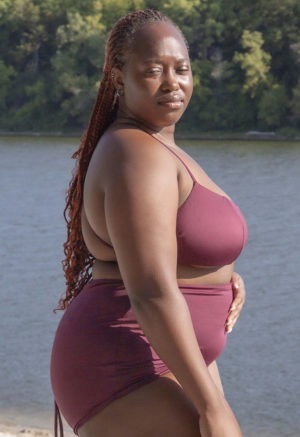 Side view of plus size model wearing Fig Ruched Top.