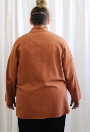 Back view of plus size model wearing Gingerbread Artist Top.