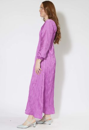 Side view of straight size model wearing Orchid Limited Edition Shirred Dress.