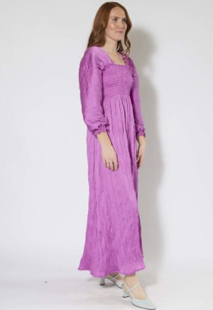 Front/side view of straight size model wearing Orchid Limited Edition Shirred Dress.