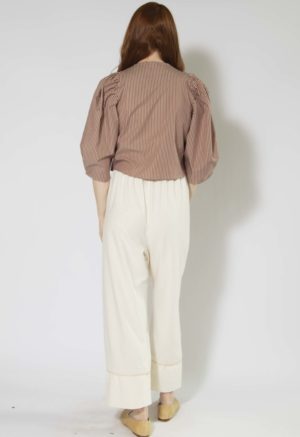 Back view of straight size model wearing Burgundy and Tan Stripe Puff Sleeve Cropped Top.
