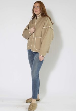 Front/side view of straight size model wearing Nomad Hemp Round Collar Jacket.