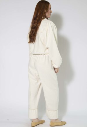 Back/side view of straight size model wearing Cream Silk Tie Front Blouse and Cuff Pant.