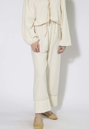 Front view of straight size model wearing Cream Silk Tie Front Blouse and Cuff Pant.