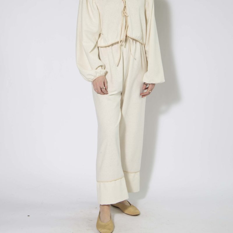 Front view of straight size model wearing Cream Silk Tie Front Blouse and Cuff Pant.