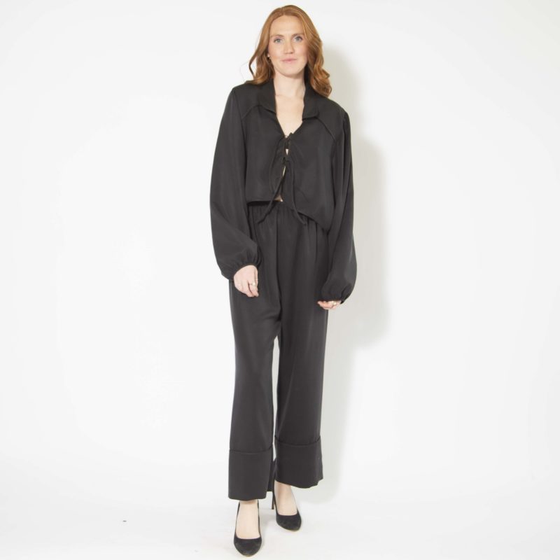 Front view of straight size model wearing Black Lyocell Tie Front Blouse and Cuff Pant.