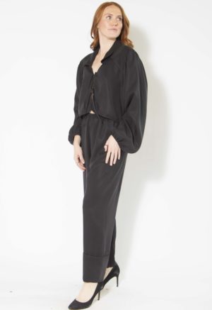 Front/side view of straight size model wearing Black Lyocell Tie Front Blouse and Cuff Pant.