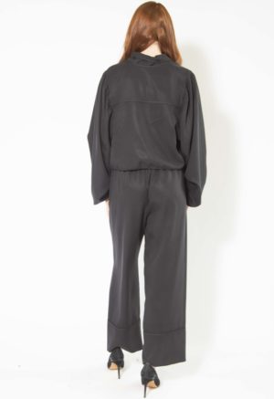 Back view of straight size model wearing Black Lyocell Tie Front Blouse and Cuff Pant.