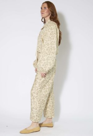 Side view of straight size model wearing Almond Floral Tie Front Blouse and Cuff Pant.