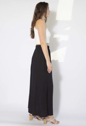 Side view of straight size model wearing Black Side Slit Maxi Skirt.