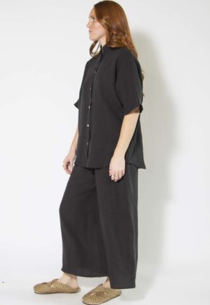 Side view of straight size model wearing Black Linen Dolman Sleeve Button-Up.