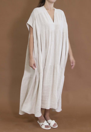 woman in oatmeal linen v-neck tiered maxi dress