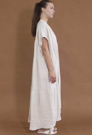 woman in oatmeal linen v-neck tiered maxi dress