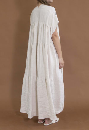 woman in oatmeal linen v-neck tiered maxi dress