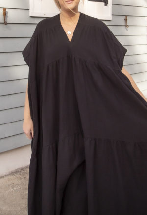 Front view of straight size model wearing Black Gauze Double V Tiered Maxi Dress.