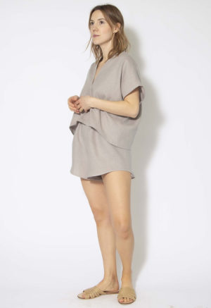Front/side view of straight size model wearing Pebble Gray Double V Cropped Top.