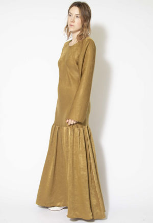 Side view of straight size model wearing Gold Dust Drop Waist Maxi Dress.