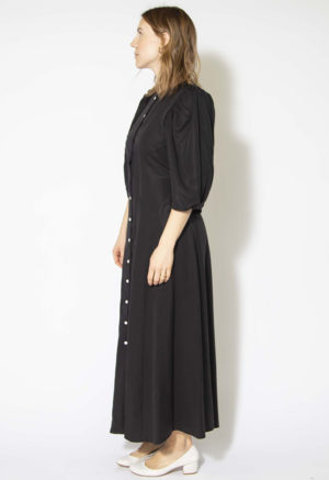 Side view of straight size model wearing Black Lyocell Button Down Dress.