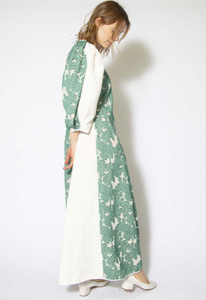 Side view of straight size model wearing Green and White Textured Floral Tie-Back Balloon Sleeve Maxi Dress.