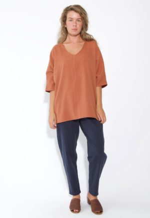 Front view of straight size model wearing Gingerbread V-Neck Top.