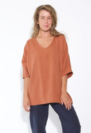Front view of straight size model wearing Gingerbread V-Neck Top.